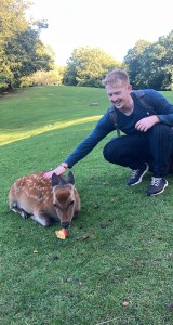 Jack of Ourtwostepstart stroking a wild deer at the Marselisborg Deer Park