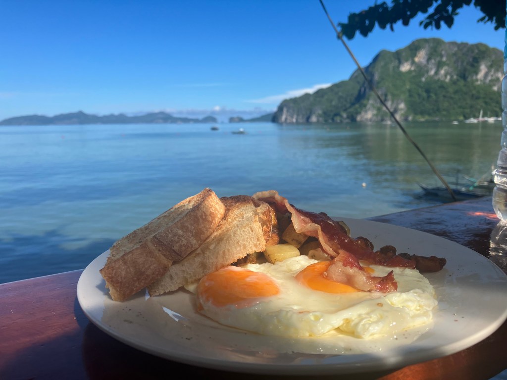 Full English breakfast with a view of El Nido beach at Outpost Hostel, Philippines
